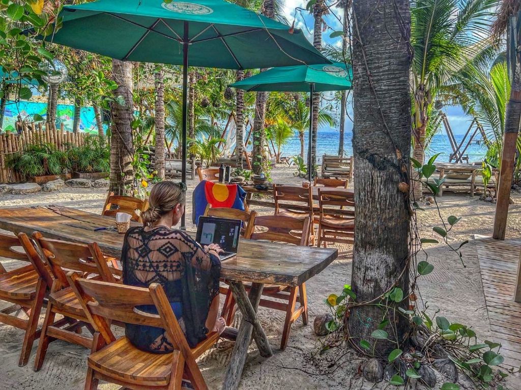 Jessica working remotely from a beachside location